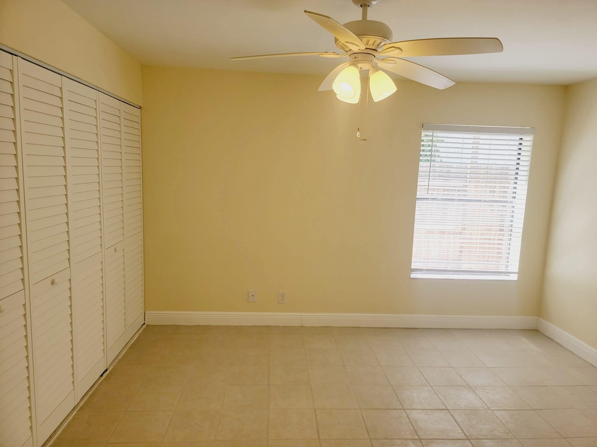 2 Crossings Circle, Unit B Boynton Beach, FL 33435 - Photo 8 of 12 an empty room with a window and a fan