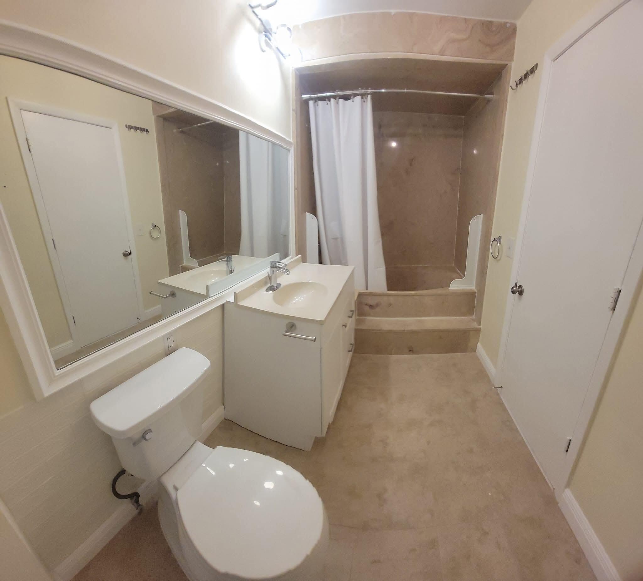 2 Crossings Circle, Unit B Boynton Beach, FL 33435 - Photo 9 of 12 a bathroom with a sink a toilet and shower
