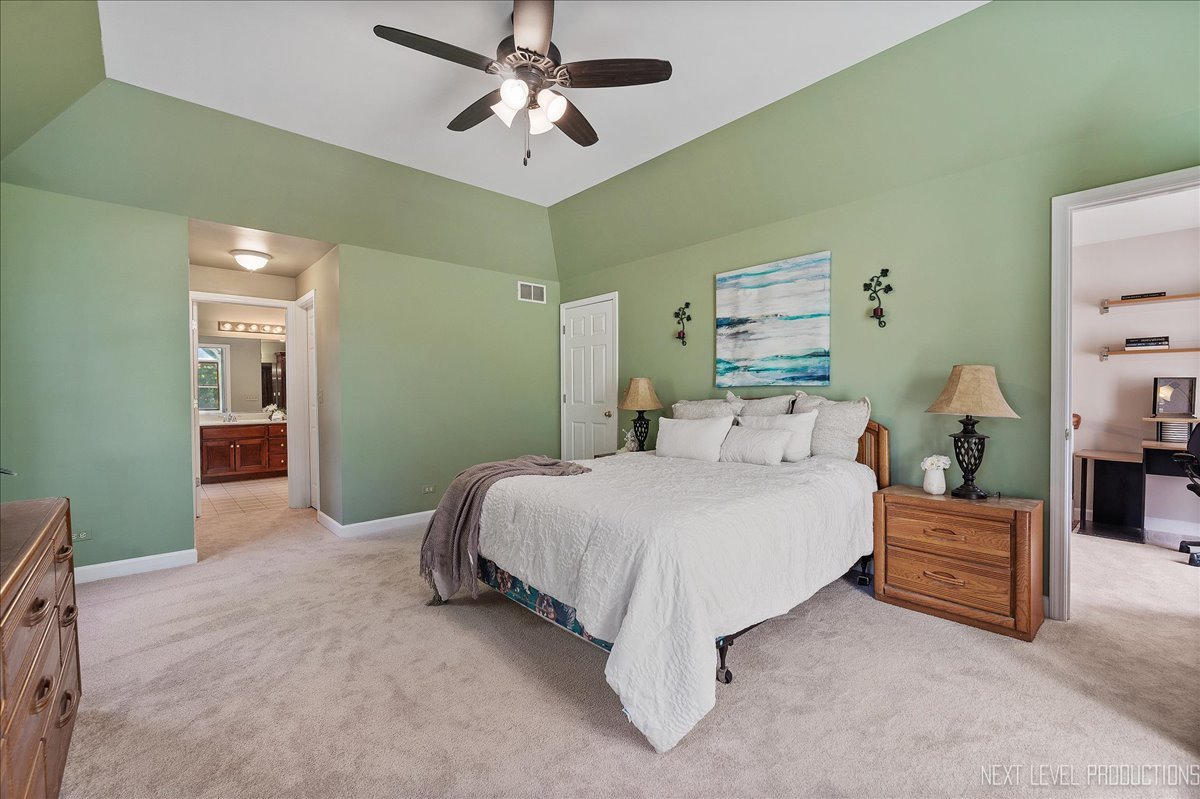 473 Bond Drive Batavia, IL 60510 - Photo 11 of 39 a spacious bedroom with a bed and a chandelier