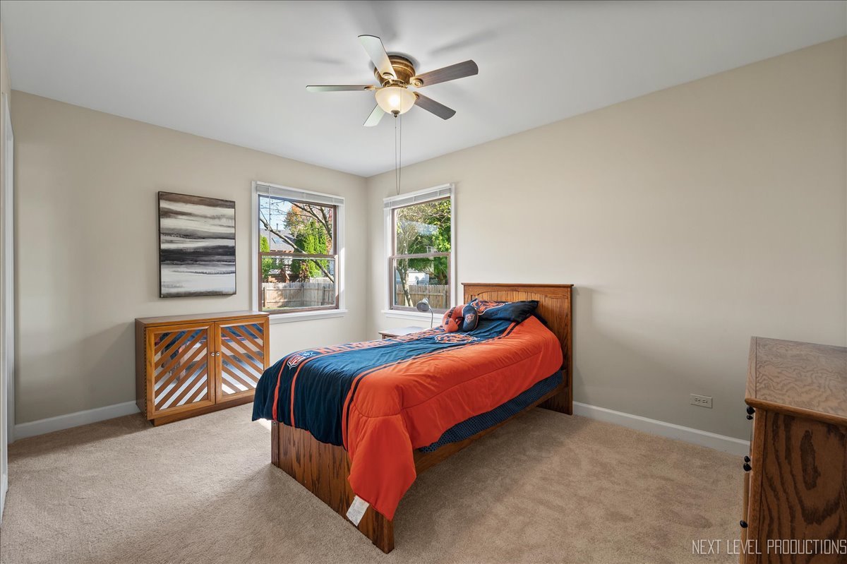 473 Bond Drive Batavia, IL 60510 - Photo 18 of 39 a bed sitting in a bedroom next to a window with a chandelier