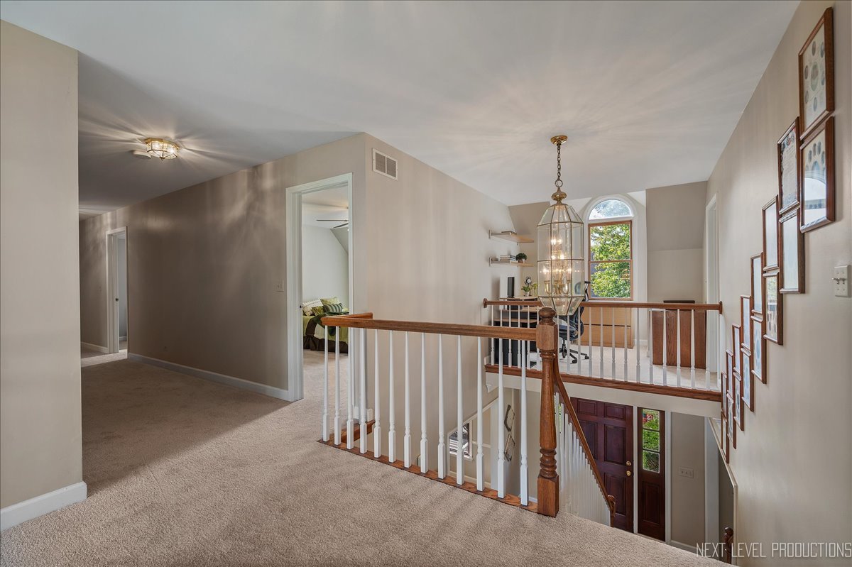 473 Bond Drive Batavia, IL 60510 - Photo 20 of 39 a view of hallway with chandelier