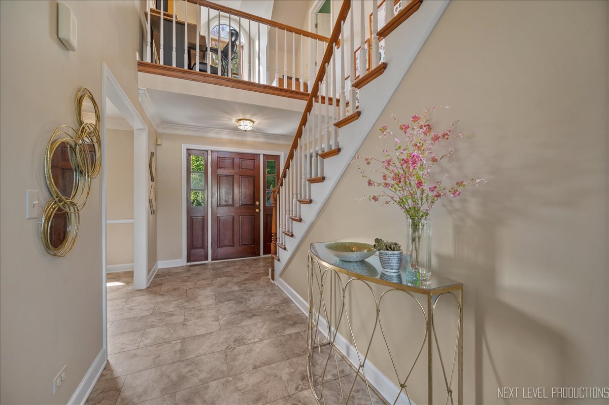 473 Bond Drive Batavia, IL 60510 - Photo 2 of 39 a view of staircase with lots of frames on wall and stairs