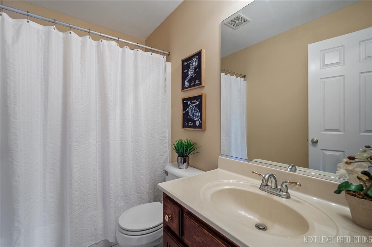 473 Bond Drive Batavia, IL 60510 - Photo 25 of 39 a bathroom with a sink toilet and mirror