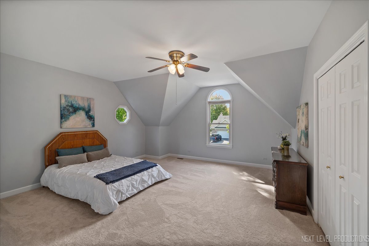 473 Bond Drive Batavia, IL 60510 - Photo 28 of 39 a bedroom with a bed and a chandelier