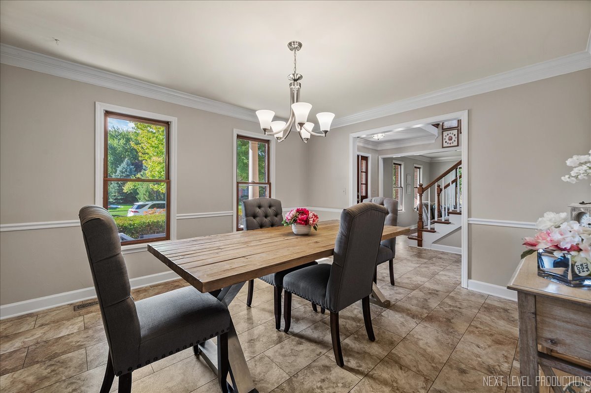 473 Bond Drive Batavia, IL 60510 - Photo 5 of 39 a dining room with furniture a rug and a chandelier
