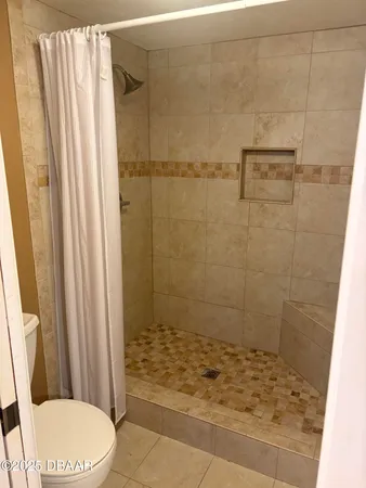 a bathroom with a shower and toilet