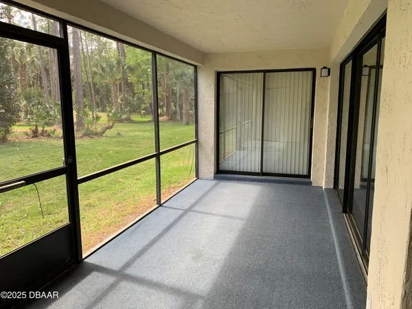 a view of empty room with large windows