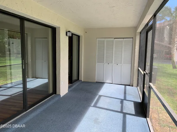 a view of hallway with a sink and glass door