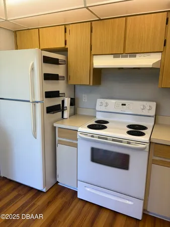 a kitchen with stainless steel appliances a stove a refrigerator and cabinets
