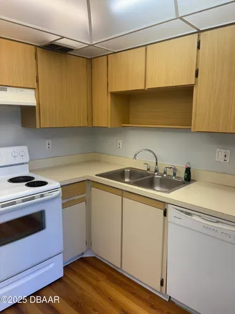 a kitchen with stainless steel appliances a sink a stove and cabinets