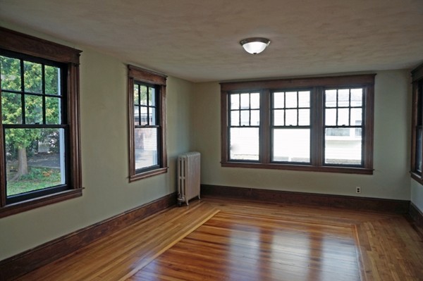58 Shawmut Street Springfield, MA 01108 - Photo 12 of 26 a view of an empty room with wooden floor and a window