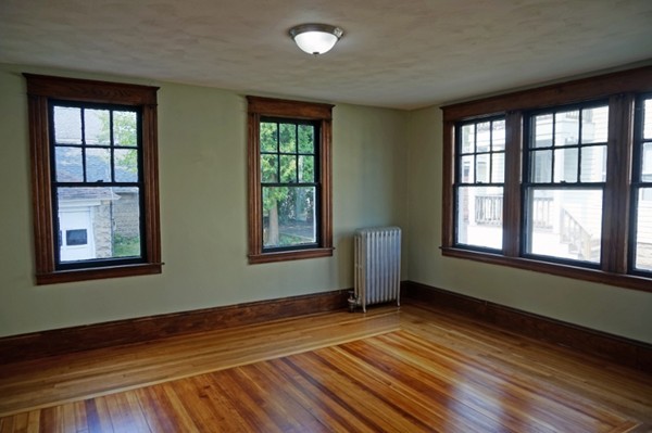 58 Shawmut Street Springfield, MA 01108 - Photo 13 of 26 a view of an empty room with wooden floor and a window