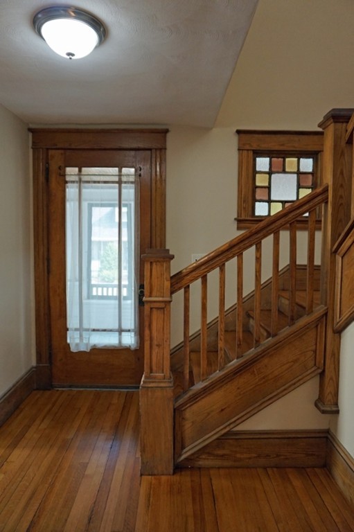 58 Shawmut Street Springfield, MA 01108 - Photo 16 of 26 a view of a hallway with wooden floor and windows