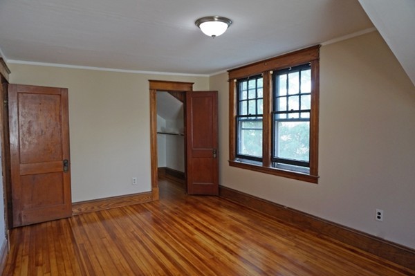 58 Shawmut Street Springfield, MA 01108 - Photo 22 of 26 an empty room with wooden floor and windows