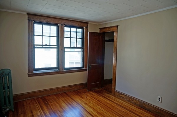 58 Shawmut Street Springfield, MA 01108 - Photo 23 of 26 an empty room with wooden floor and windows