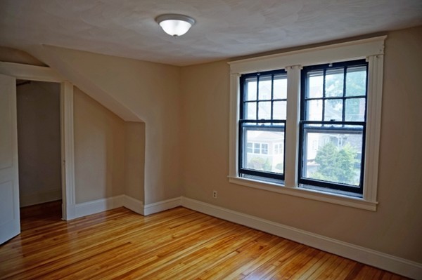 58 Shawmut Street Springfield, MA 01108 - Photo 24 of 26 an empty room with wooden floor and windows