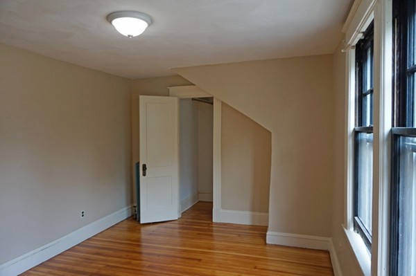 58 Shawmut Street Springfield, MA 01108 - Photo 25 of 26 a view of an empty room with wooden floor and a window