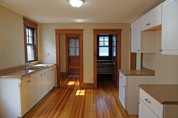 58 Shawmut Street Springfield, MA 01108 - Photo 8 of 26 a view of a kitchen with wooden floor and electronic appliances
