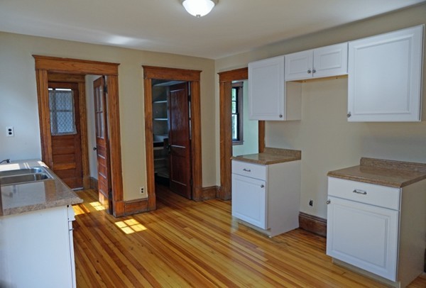 58 Shawmut Street Springfield, MA 01108 - Photo 9 of 26 a kitchen with a refrigerator and cabinets