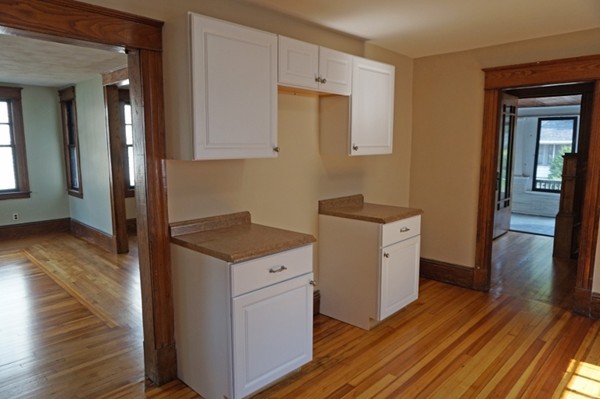 58 Shawmut Street Springfield, MA 01108 - Photo 10 of 26 a kitchen with a stove and a wooden floor