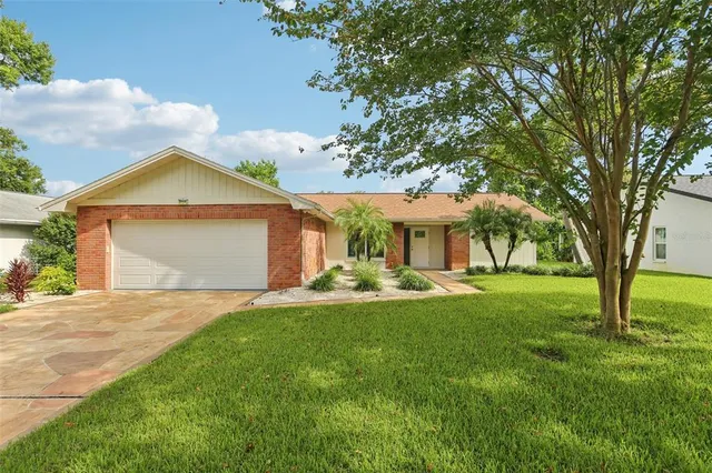 a front view of a house with yard and green space