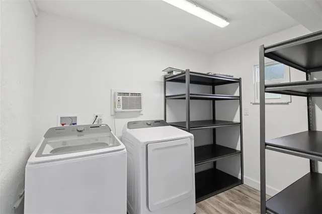 a kitchen with a stove a refrigerator and white cabinets