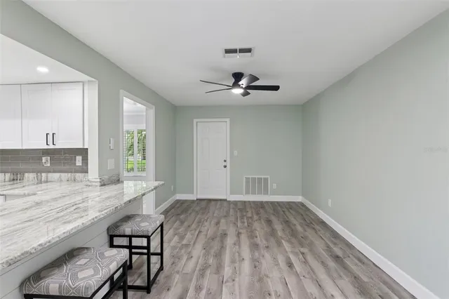 a kitchen with white cabinets stainless steel appliances and a counter space
