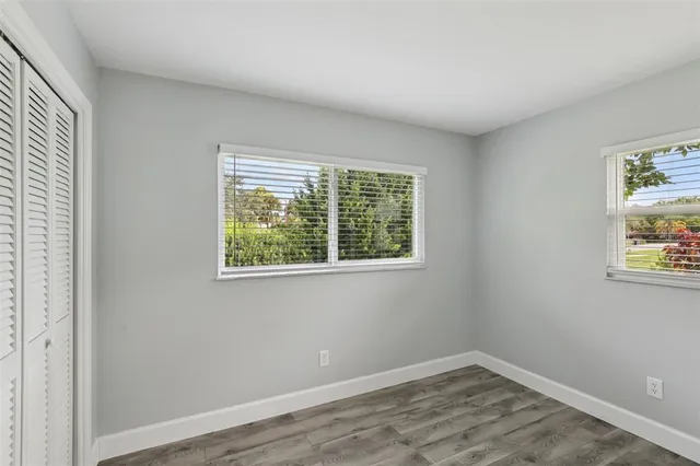 an aerial view of residential houses with outdoor space and parking
