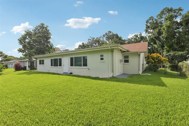 an aerial view of residential houses with outdoor space and street view