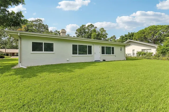 an aerial view of residential houses with outdoor space and street view