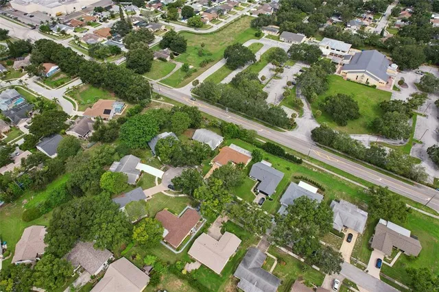 an aerial view of a house with a garden and outdoor seating