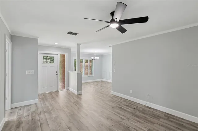 a view of an empty room with wooden floor