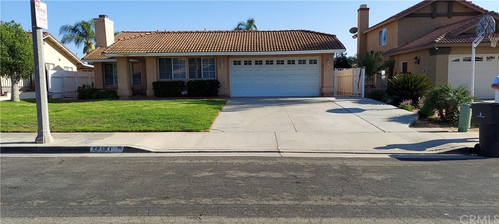 20121 Sweetbay Road Riverside, CA 92508 - Photo 1 of 1 a front view of a house with a yard and garage