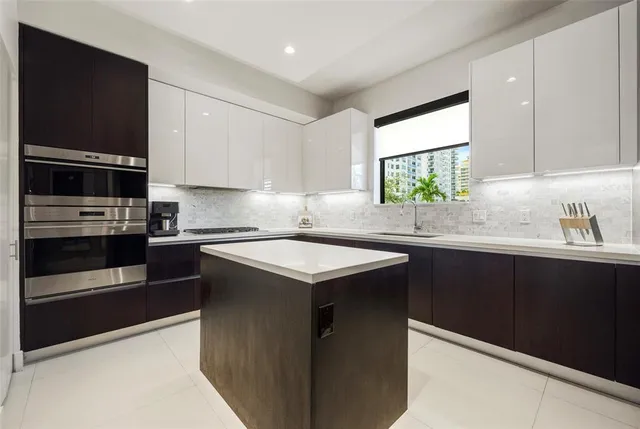 a kitchen with stainless steel appliances granite countertop a sink stove and microwave
