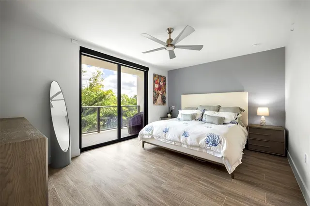 a bedroom with a large bed and a large window