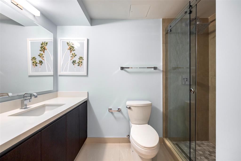 3030 North Ocean Boulevard, Unit S106 Fort Lauderdale, FL 33308 - Photo 22 of 40 a white toilet sitting next to a bathroom sink