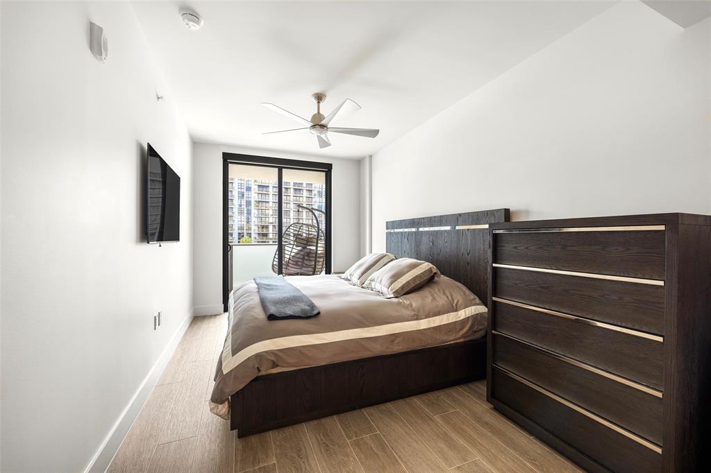 3030 North Ocean Boulevard, Unit S106 Fort Lauderdale, FL 33308 - Photo 24 of 40 a bedroom with a bed and wooden floor