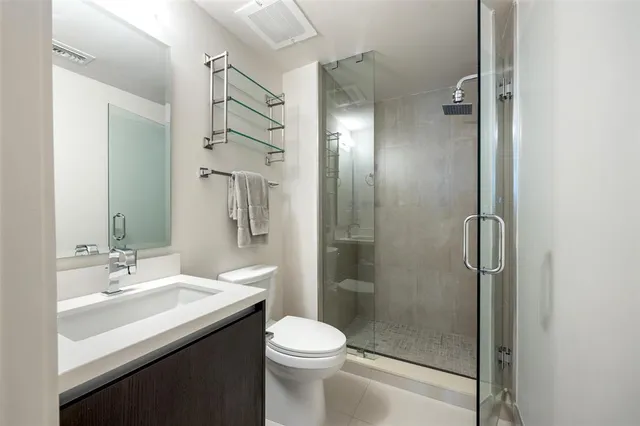 a bathroom with a sink toilet and shower