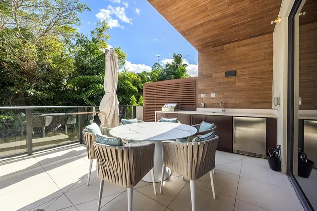 a view of a patio with a table and chairs