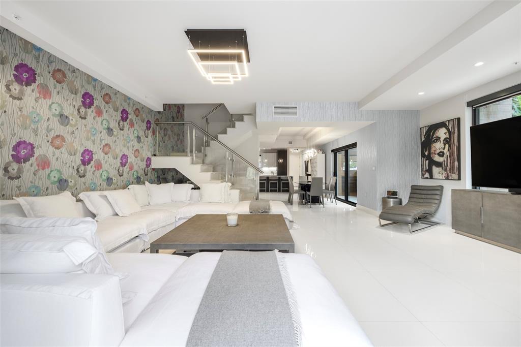 3030 North Ocean Boulevard, Unit S106 Fort Lauderdale, FL 33308 - Photo 4 of 40 a living room with furniture and a flat screen tv