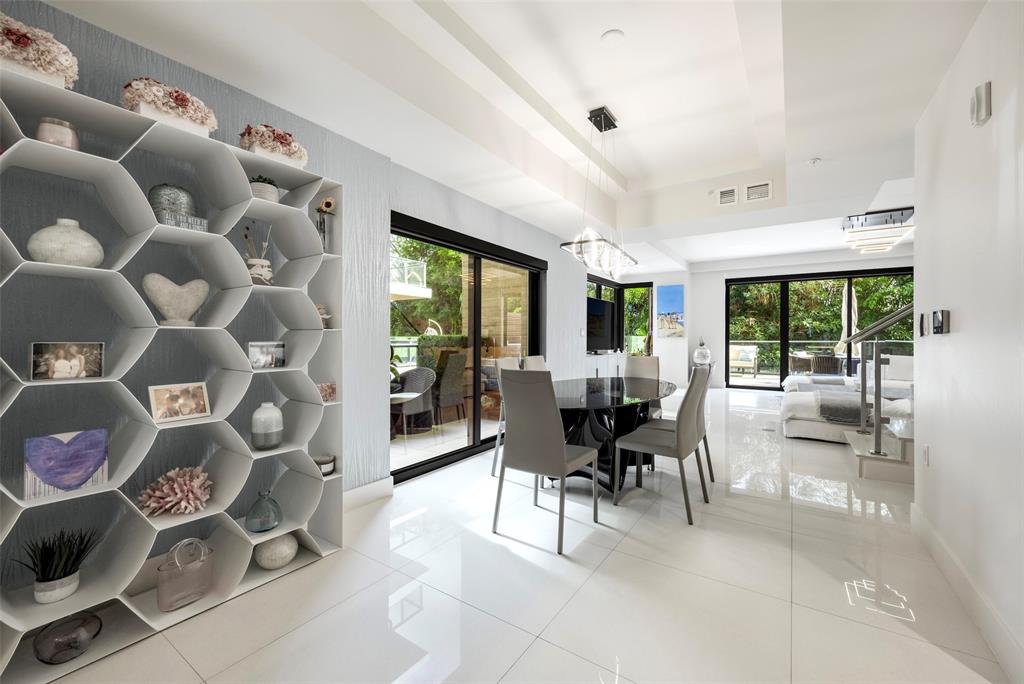 3030 North Ocean Boulevard, Unit S106 Fort Lauderdale, FL 33308 - Photo 6 of 40 a dining room with furniture and floor to ceiling window