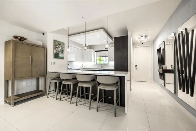 a large kitchen with a table and chairs
