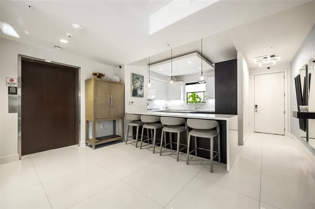 a large kitchen with a table and chairs