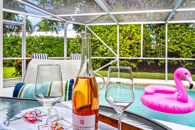 a view of a swimming pool with a dining table and chairs