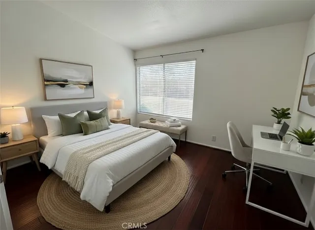 a bedroom with a bed and a desk