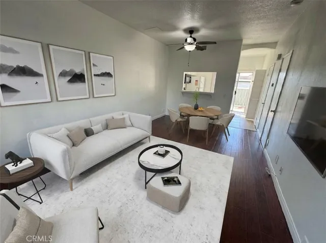 a living room with furniture a rug and a chandelier