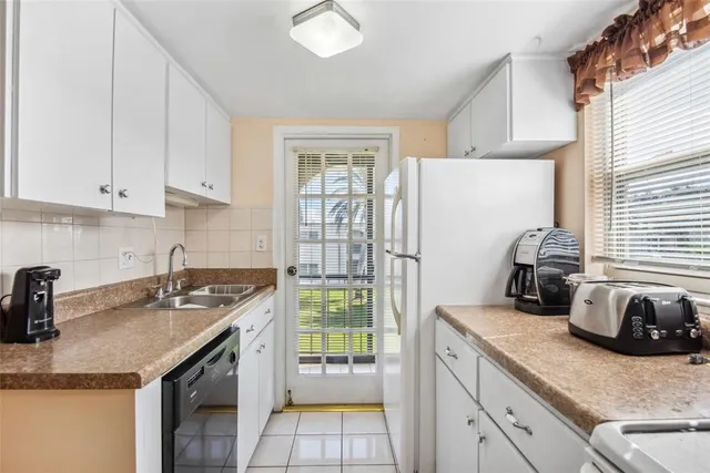 a kitchen with a sink a stove and cabinets