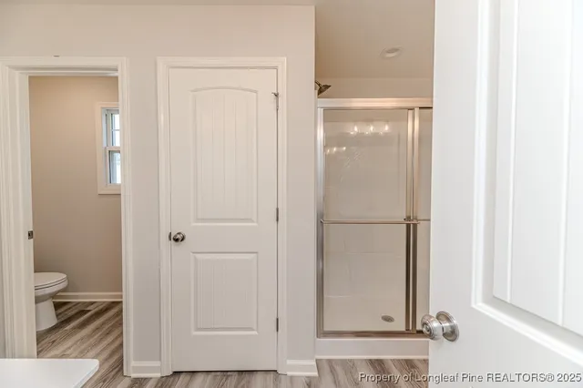 a bathroom with a glass shower door