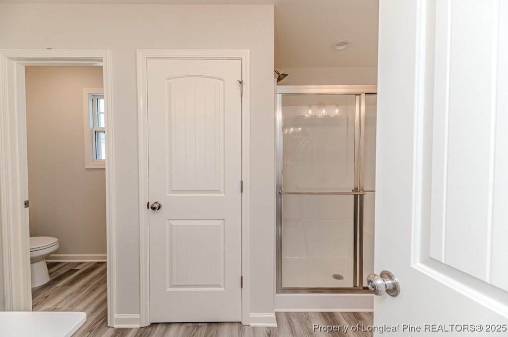 87 Onslow Court Spring Lake, NC 28390 - Photo 17 of 32 a bathroom with a glass shower door