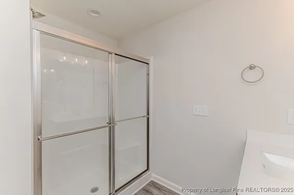 a bathroom with a glass shower door
